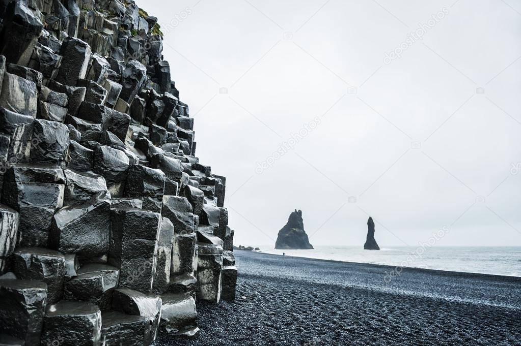 Mount Reynisfjall with basalt columns and Reynisdrangar rock for