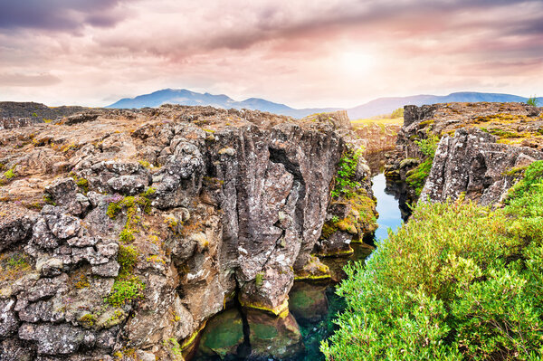 Cliffs and deep fissure in Thingvellir National Park, southern I