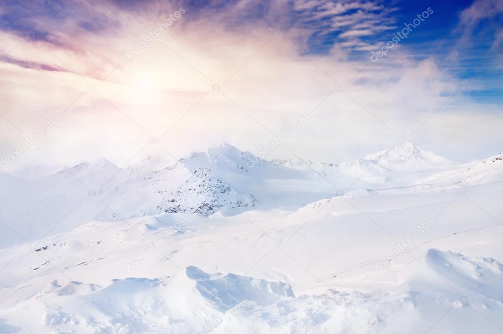 Beautiful winter landscape with snow-covered mountains at sunset