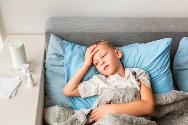 Niño Enfermo Con Fiebre Alta Dolor Cabeza Acostado Cama Sosteniendo —  Fotos de Stock