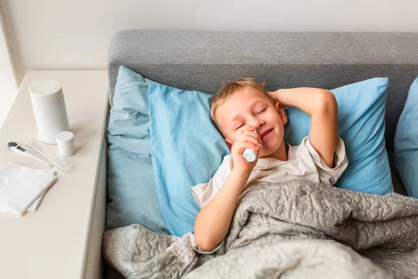 Sick Little Boy High Fever Headache Laying Bed Spraying Medicine — Stock Photo, Image