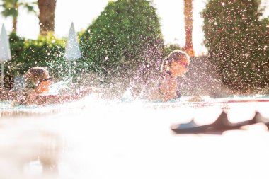 Mutlu güzel kızlar tatil köyündeki havuzda eğleniyor.