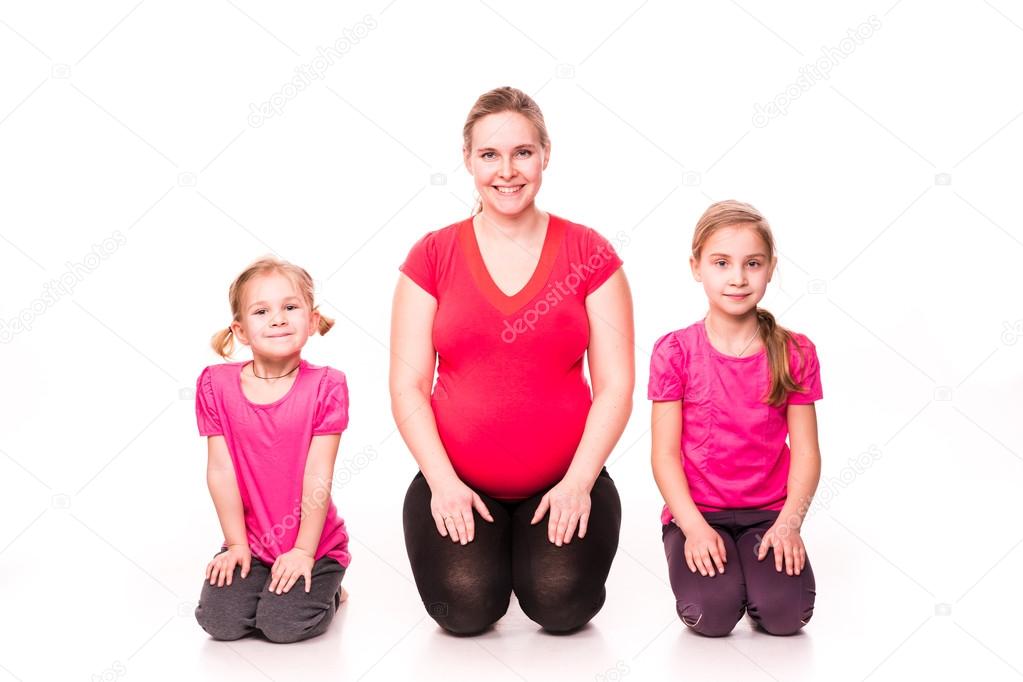 Pregnant woman with kids exercising isolated