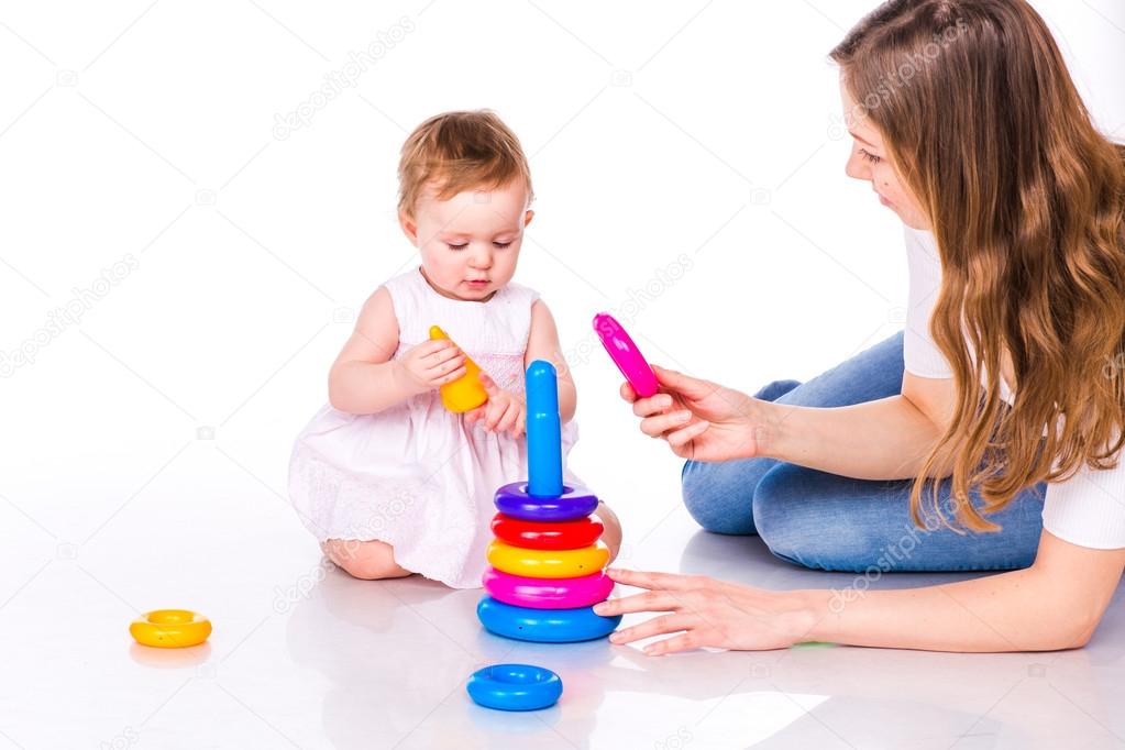 Baby with mother playing with stacking rings