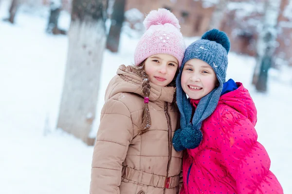 Happy girls playing on snow in winter — Stock Photo, Image