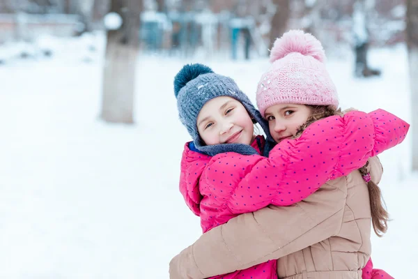 Happy girls playing on snow in winter — Stock Photo, Image