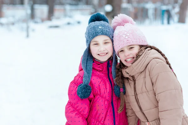 Happy girls playing on snow in winter — Stock Photo, Image