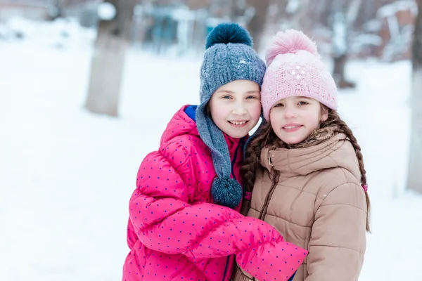 Happy girls playing on snow in winter — Stock Photo, Image