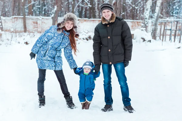 Happy family playing on snow