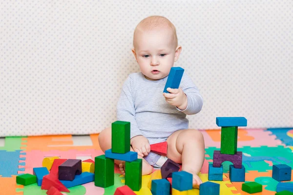 Cute little baby playing with colorful toys — Stock Photo, Image