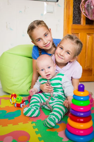 Glückliche Kinder spielen mit kleinem Bruder — Stockfoto