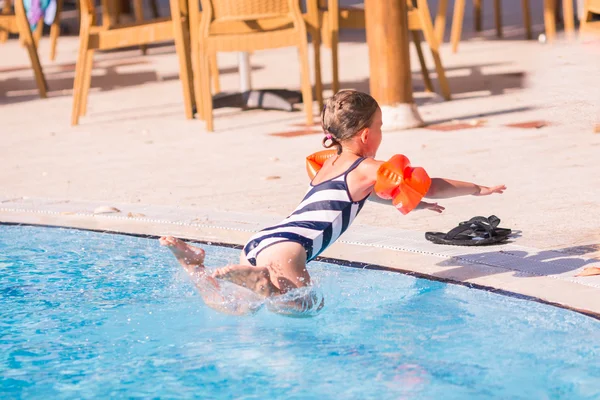 Cute little girl is ready to jump into pool — Stock Photo, Image