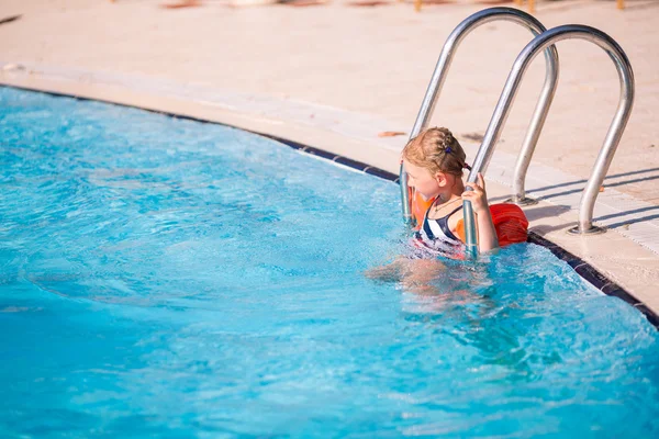 Cute little girl is ready to jump into pool — Stock Photo, Image