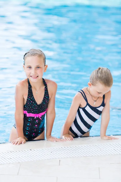 スイミング プールの 2 つのかわいい小さな女の子 — ストック写真