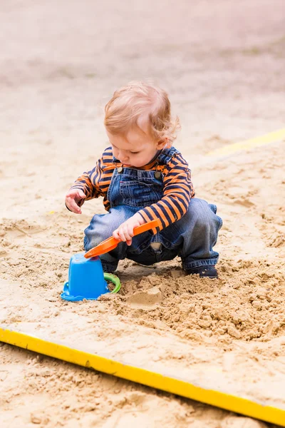 Χαριτωμένο αγοράκι που παίζει με την άμμο — Φωτογραφία Αρχείου