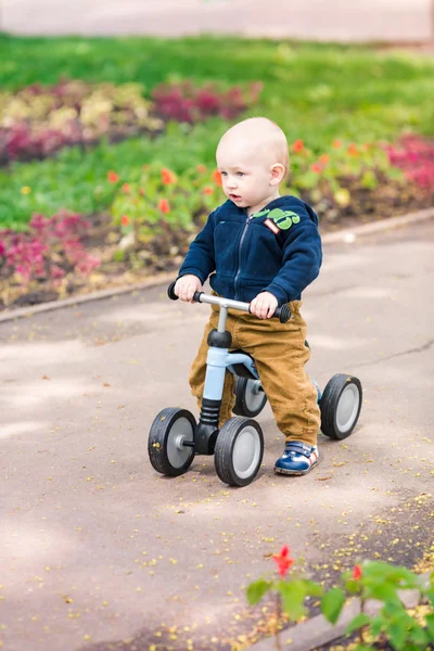 Cute baby boy on his first running bike — Stock Photo, Image