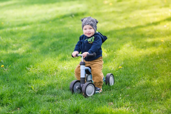 Cute baby boy on his first running bike — Stock Photo, Image