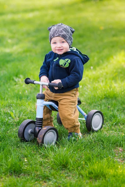 Cute baby boy on his first running bike — Stock Photo, Image