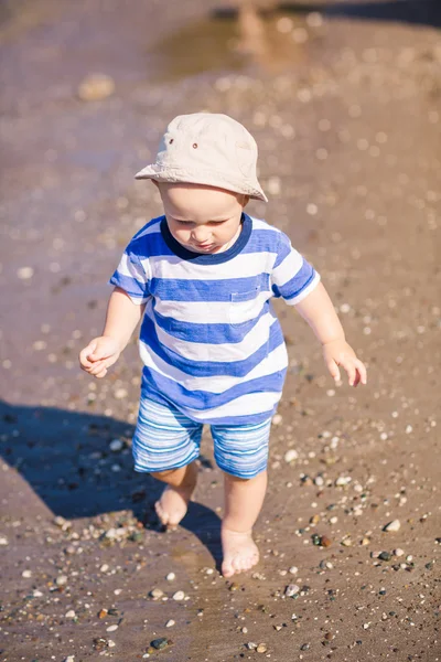 Милый маленький мальчик, исследующий пляж — стоковое фото