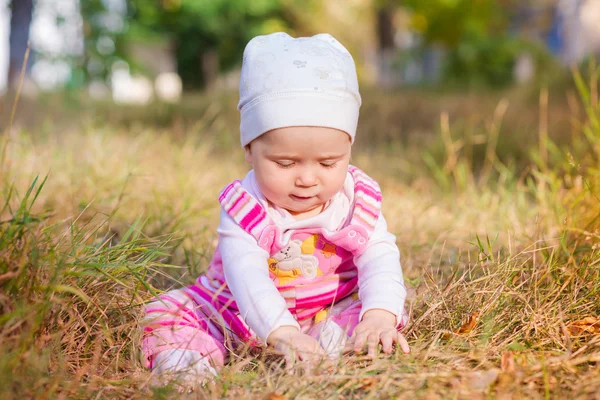 Cute baby in autumn leaves. — Stock Photo, Image