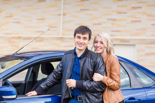 Joyeux jeune couple debout près de la voiture — Photo