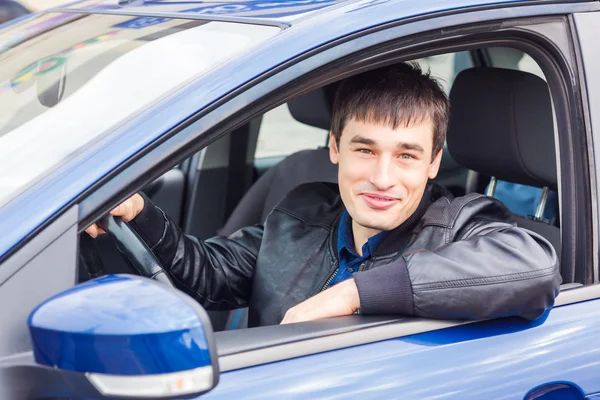 Handsome young man sitting in his car — Stock Photo, Image