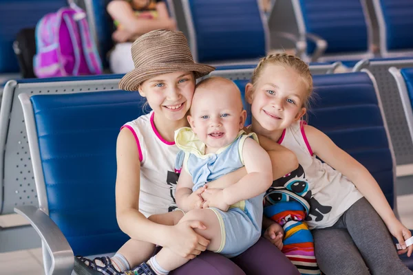 Šťastné děti čeká na let uvnitř letiště — Stock fotografie