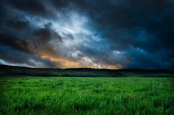 Field and dramatic sky view — Stock Photo, Image