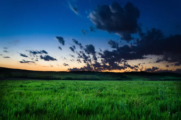 Field and dramatic sky view — Stock Photo, Image