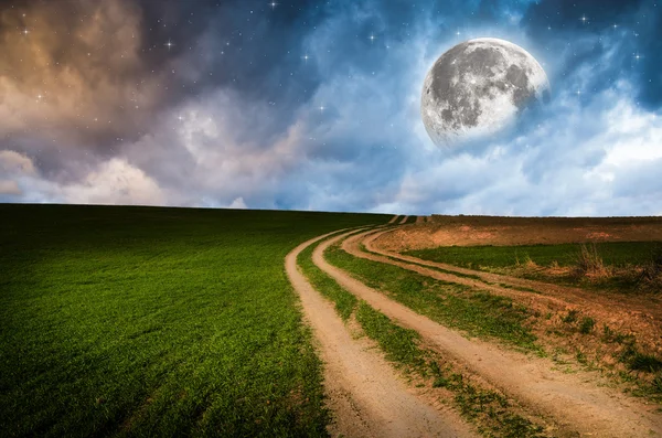 Rural road and sky with stars in the night