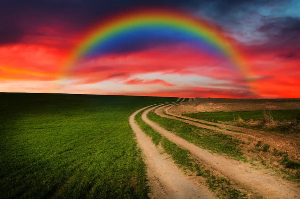 Rural road and rainbow in the night — Stock Photo, Image