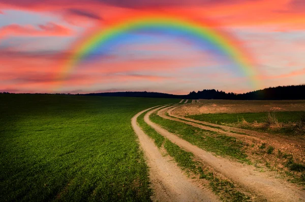 Rural road and rainbow in the night — Stock Photo, Image