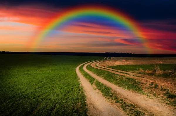 Rural road and rainbow in the night — Stock Photo, Image