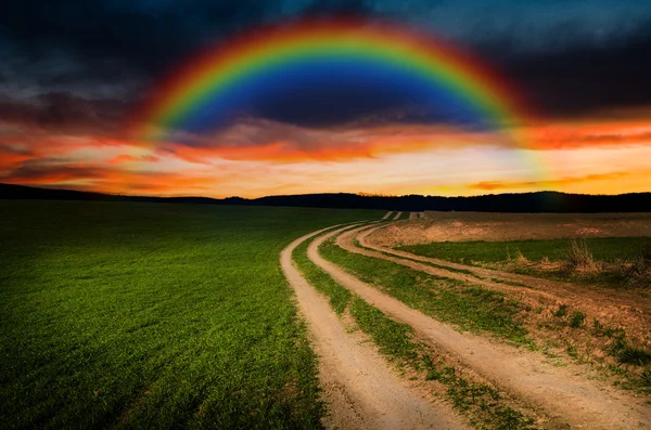 Rural road and rainbow in the night — Stock Photo, Image