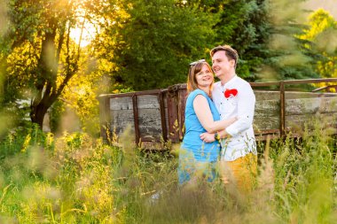 Mutlu ve aşık. Köydeki çayırlarda kucaklaşan genç çift..