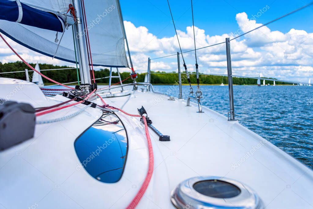 view from a main deck of sailboat on a lake. Summer vacations, cruise, recreation, sport, regatta, leisure activity, service, tourism