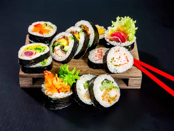Set Sushi Rolls Wooden Board Black Background Different Kind Maki — Stockfoto