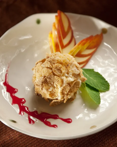 Delicious restaurant dessert, fried ice cream served with whipped cream and fruit coulis — Stock Photo, Image