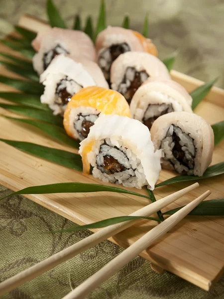 Sushi rolls on a wooden board — Stock Photo, Image
