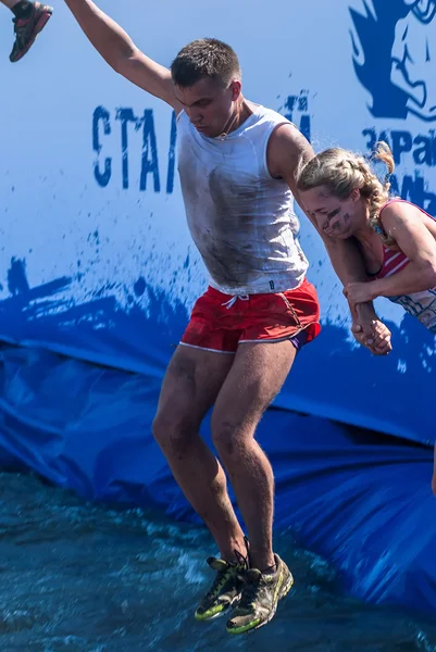 Man with girl jump in water in extrim racing