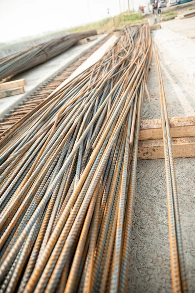 Stack of heavy metal reinforcement bars with periodic profile texture