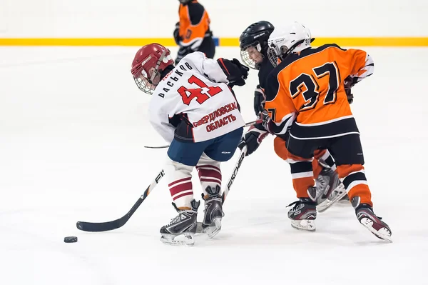 Game between children ice-hockey teams