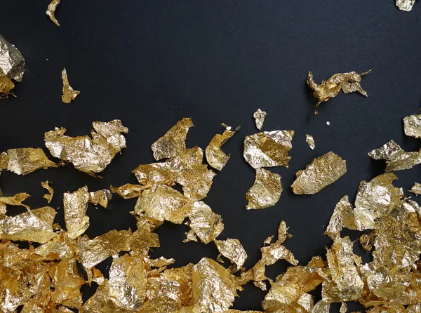 Restjes van goud folie met lege ruimte — Stockfoto