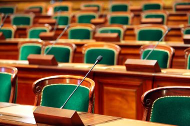 Empty vintage congress hall with seats and microphones. clipart