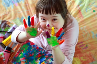 Cute little girl with painted hands clipart