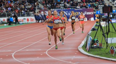 Katie Mackey from USA winning 1500 m. race on DecaNation International Outdoor Games clipart