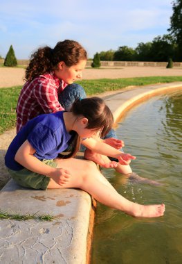 Young girls playing with the fountain clipart