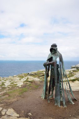 Gallo statue overlooking cornish coast at Tintagel. Inspired by Legend of King Arthur clipart