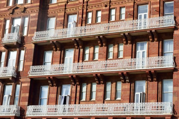 Large red bricked hotel with white balcony