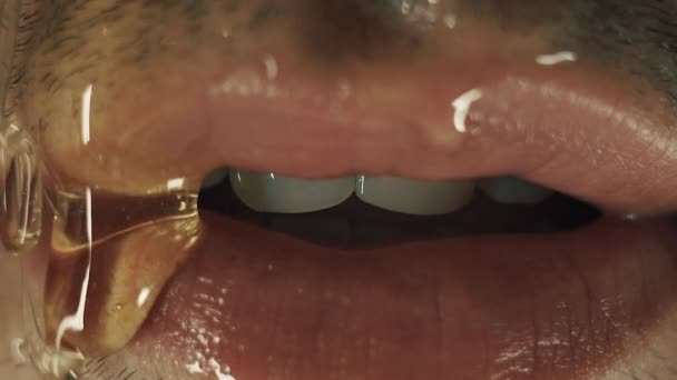 Male lips with honey. Closeup on mouth — Stock Video